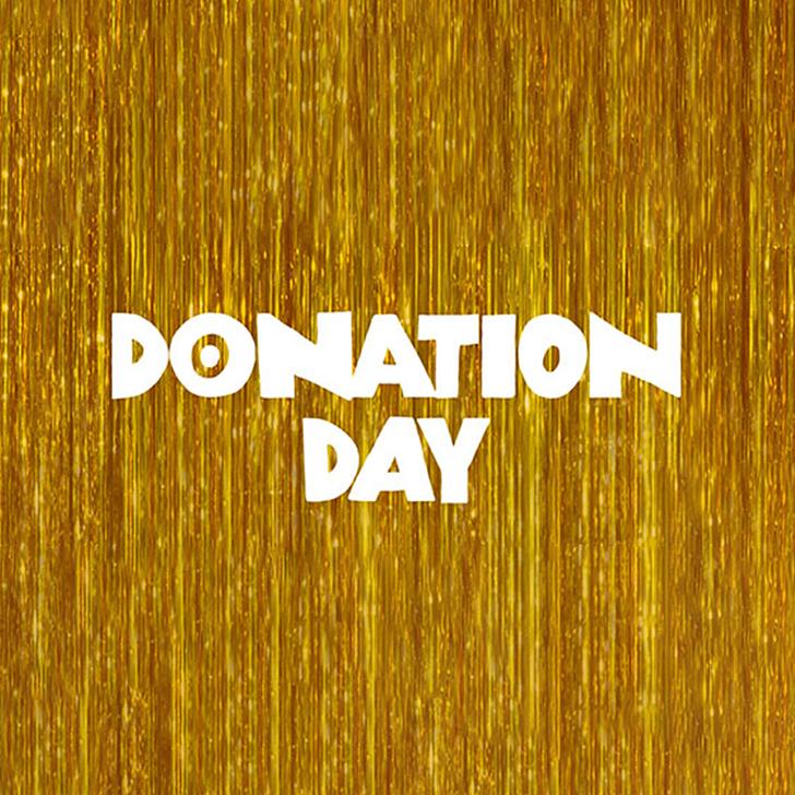 Gold glitter backdrop with white wording on the top that says Donation Day