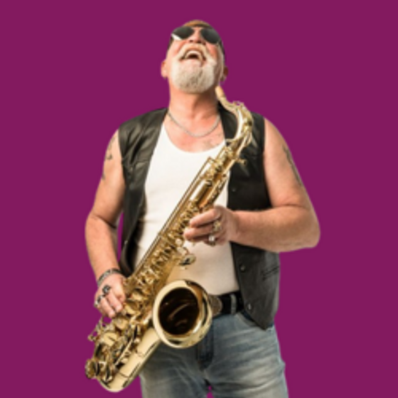 Man playing a saxophone wearing jeans, white tshirt and leather vest against a purple background