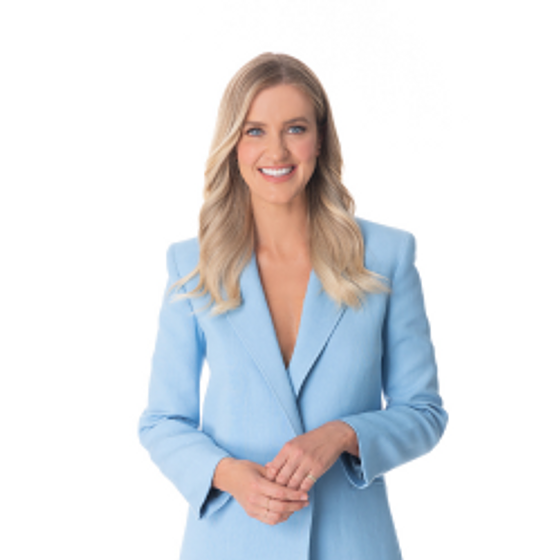 Kate Freebairn wearing a blue suit smiling at the camera