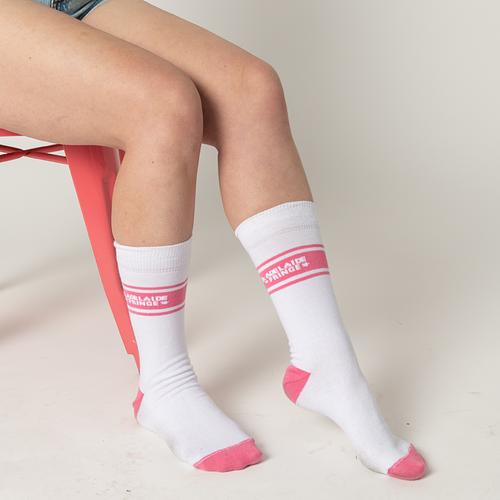 Close up image of a person wearing pink and white Adelaide Fringe socks on their feet