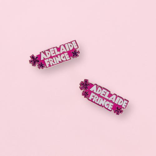 Two Adelaide Fringe pins on light pink background
